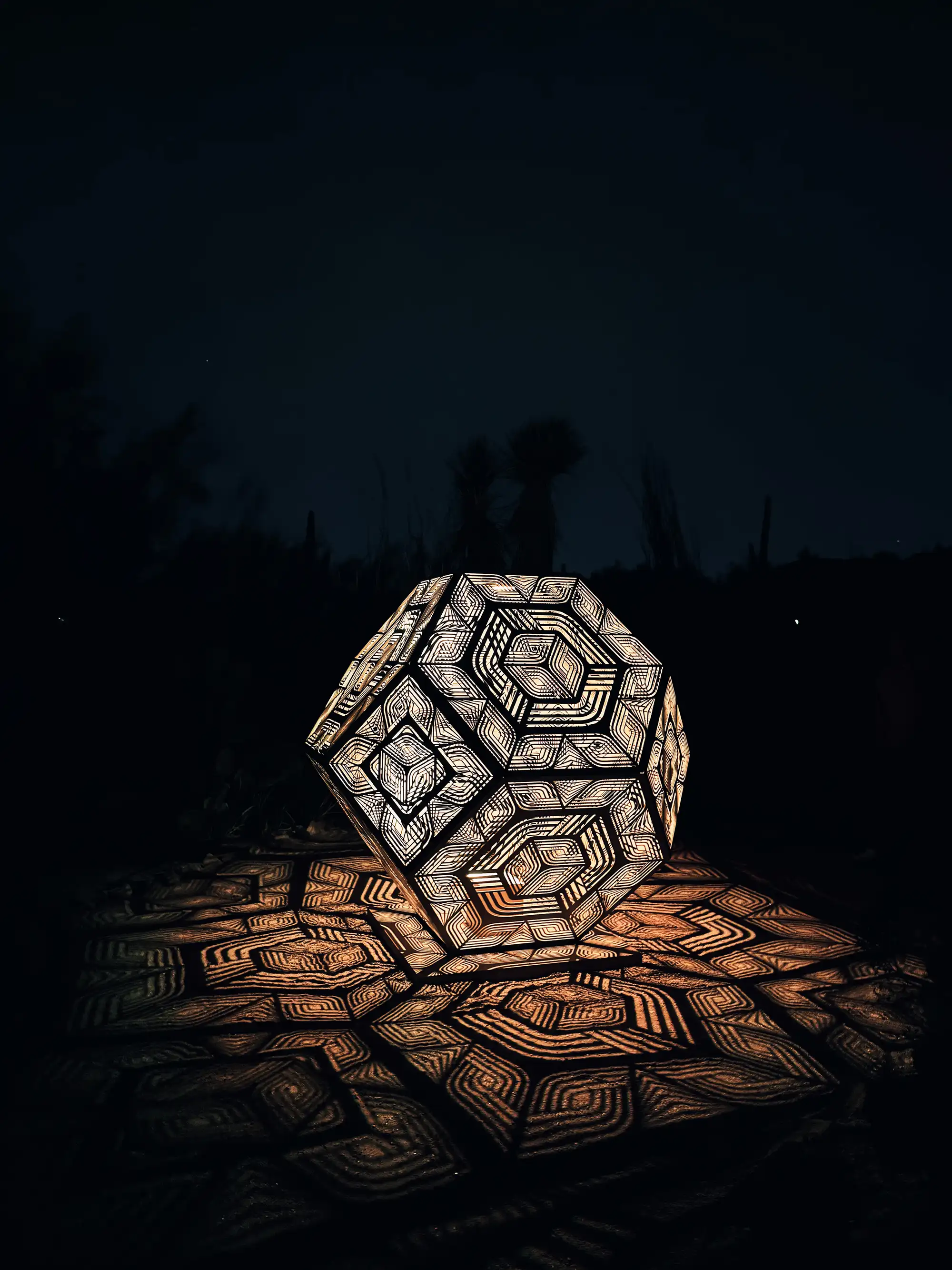 alt: A geometric light sculpture casting geometric patterns from its shadows.